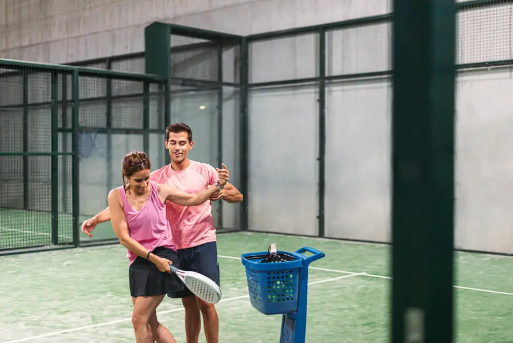 Padel coach with player