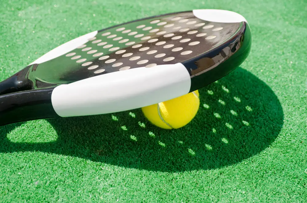 Round padel racket on padel court